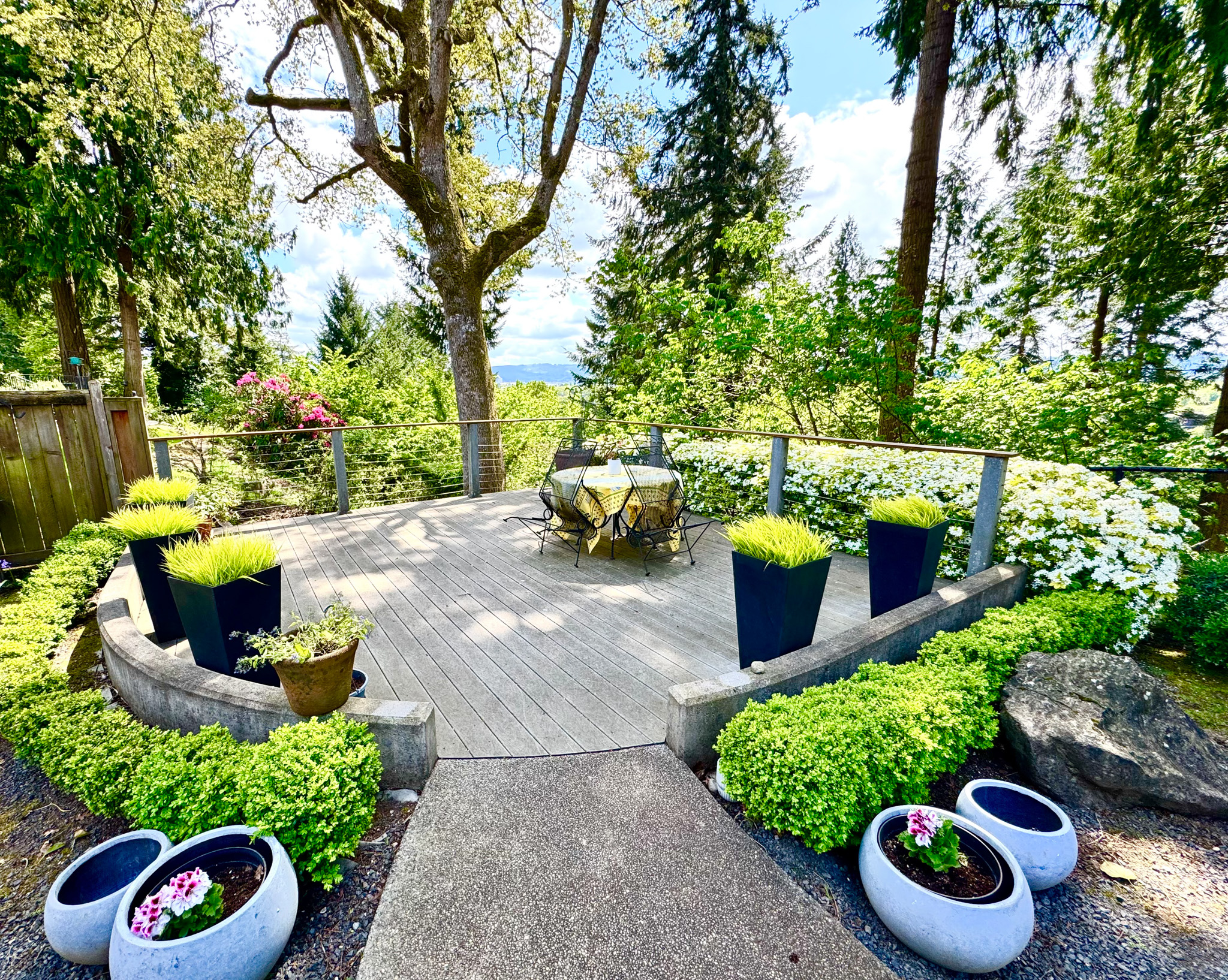 Landscaped terrace with planters and garden views
